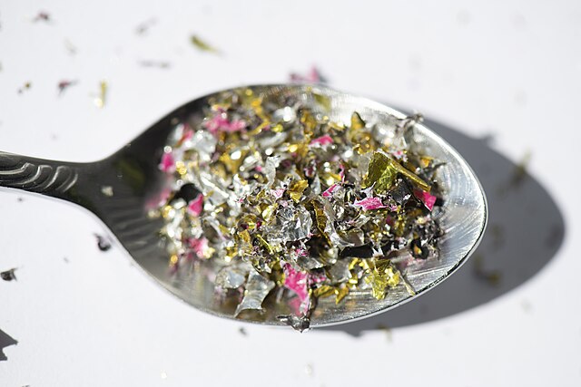 Spoon filled with microplastic particles.